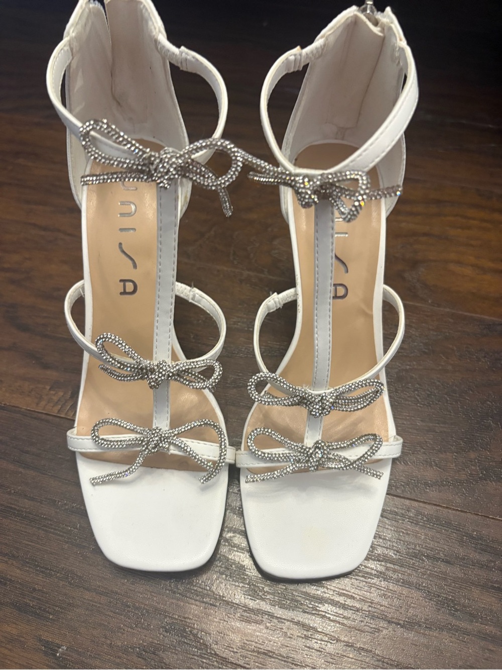 Unisa White T-Strap Heels with Rhinestone Bow Accents